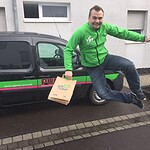 Mann springt vor einem PURA Fahrzeug bei einer Roadshow.